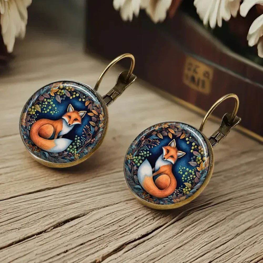 Aretes de vidrio en forma de dome con animales caprichosos