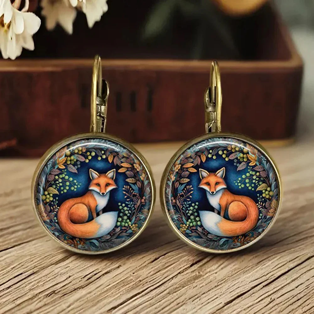 Aretes de vidrio en forma de dome con animales caprichosos
